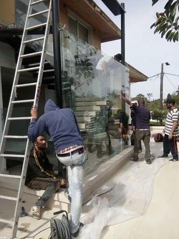 L'équipe AluGlass pose de grands panneaux de verre autour d'un escalier extérieur, villa à Rabat